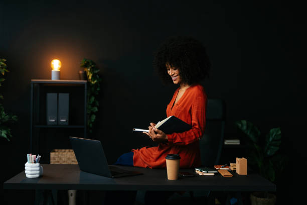 istock Smiling young manager working late at night in office 2189558089