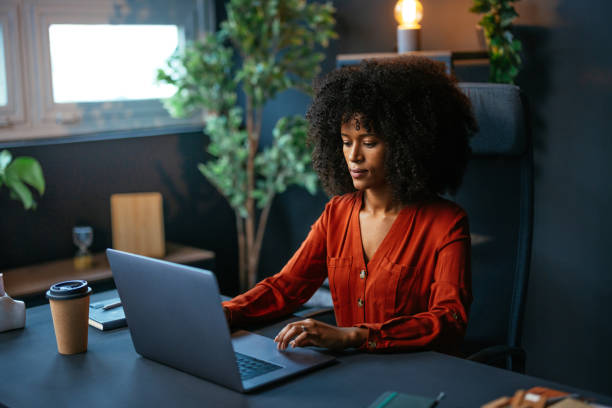 istock Focused young female entrepreneur working on laptop in modern office 2189558100