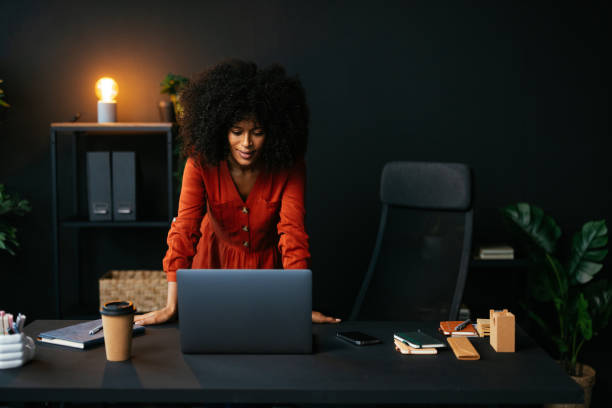 Young businesswoman working on a laptop in modern office