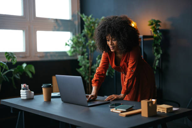 istock Young female freelancer working on laptop in home office 2189558106