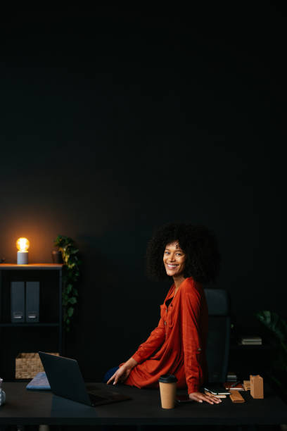 istock Young female entrepreneur smiling at camera in modern office 2189558125