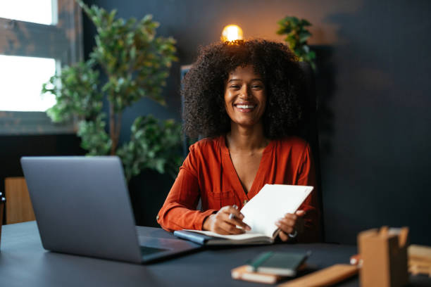 istock Young manager working at her desk smiling at the camera 2189558131