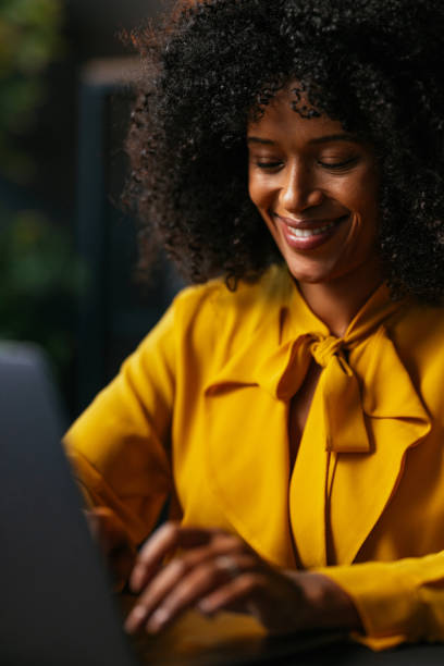 istock Smiling black businesswoman working on laptop in office 2189558201