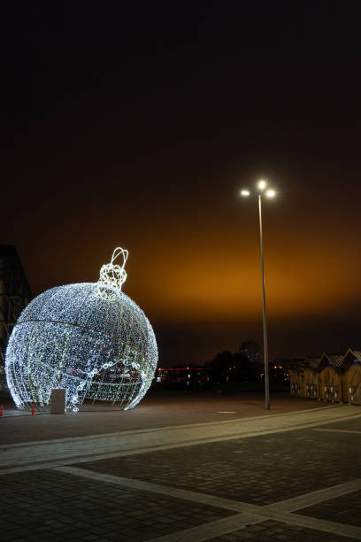 istock Glowing Christmas tree ball on an orange sky background. Christmas background 2189558961