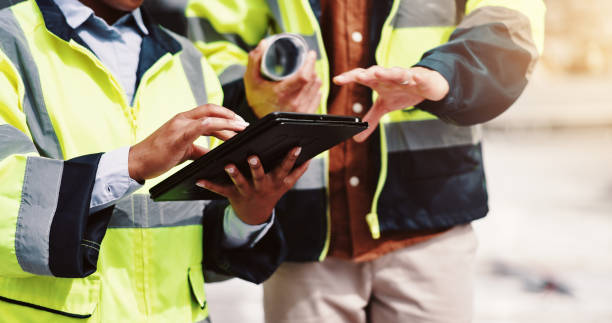 istock People, hands and tablet in city for engineering, urban development and project management. Architect team, discussion and outdoor with technology for meeting, brainstorming and building renovation 2189559123