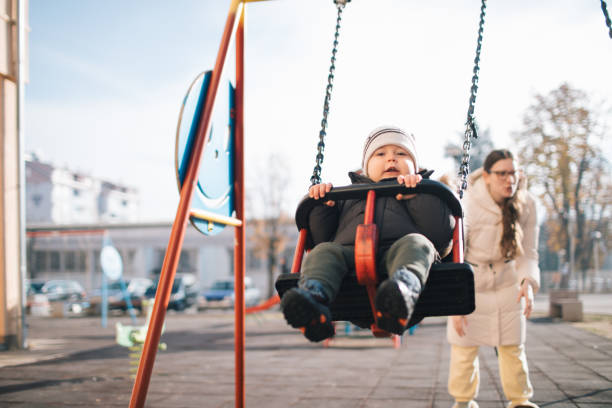 istock Toddler enjoy swinging in the playgorund 2189559148