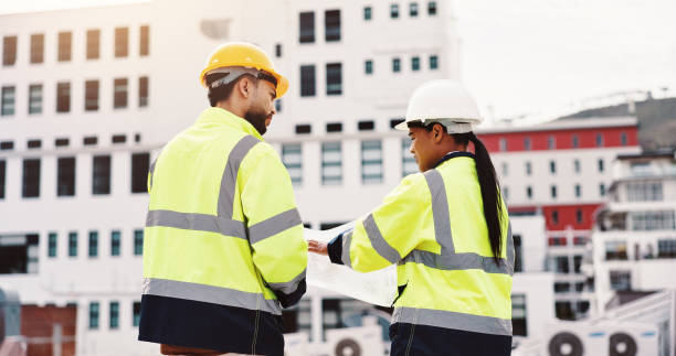 istock People, planning and paper in city for engineering, urban development and project management. Contractor, supervisor and outdoor with blueprint for meeting, brainstorming and building renovation 2189559155