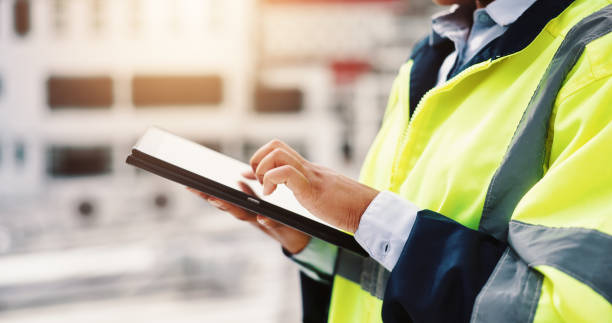 istock Hands, engineering and construction site with tablet, outdoor and designer for project or development. Person, technology and helmet for safety, infrastructure and industry in inspection or logistics 2189559192