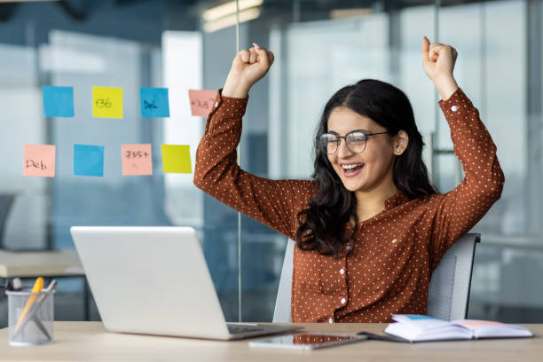 istock Happy businesswoman celebrating success while working in a modern office 2189560708