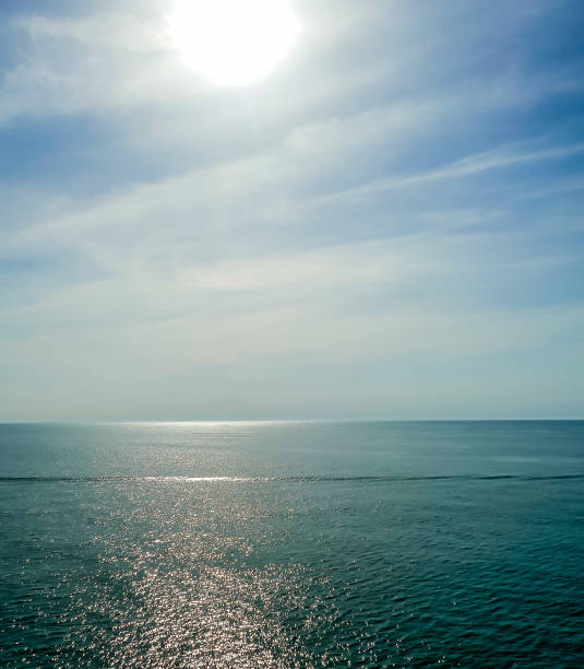 istock A calm ocean with a bright sun shining on the water 2189564318