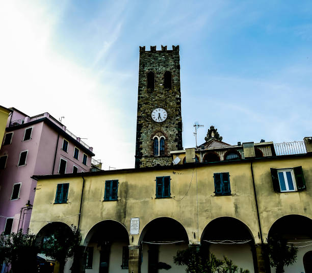istock A clock tower with a clock on it is in the middle of a city 2189564373