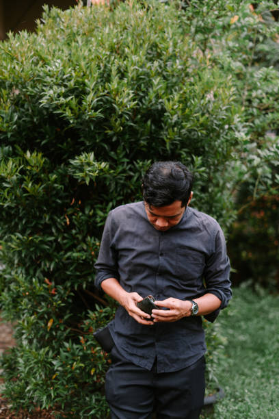 istock A Southeast Asian man checking his wallet, captured in a candid moment, 2189565244