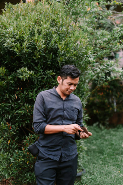 istock A Southeast Asian man checking his wallet, captured in a candid moment, 2189565465