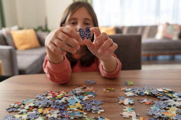istock Little girl playing with puzzles at home 2189565480