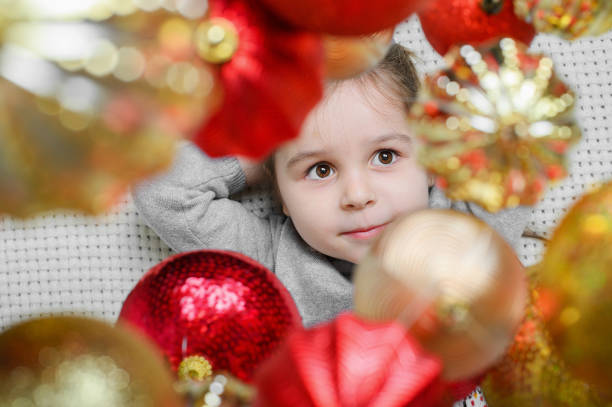Dreamy Child Among Festive Christmas Ornaments.
