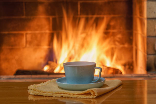 istock Cozy fireplace,winter vacation, a mug of coffee, fire burning 2189567040