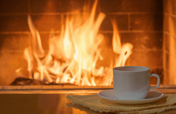 Cozy fireplace,winter vacation, a cup of coffee, fire burning.