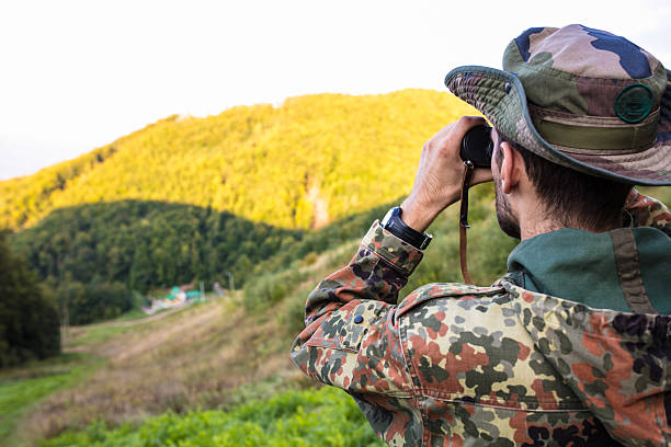 istock Soldier observing enemy positions with binoculars in mountain forest 2189567847
