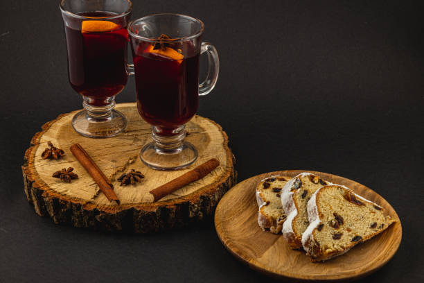 istock aromatic mulled wine with fresh stollen on a wooden plate on a black background 2189568403