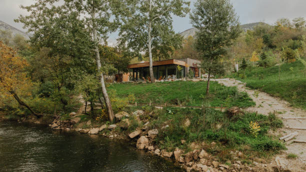 Photo of a wooden cabin house on riverbank