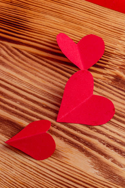 hand cut small red paper hearts on a chalkboard High quality photo.