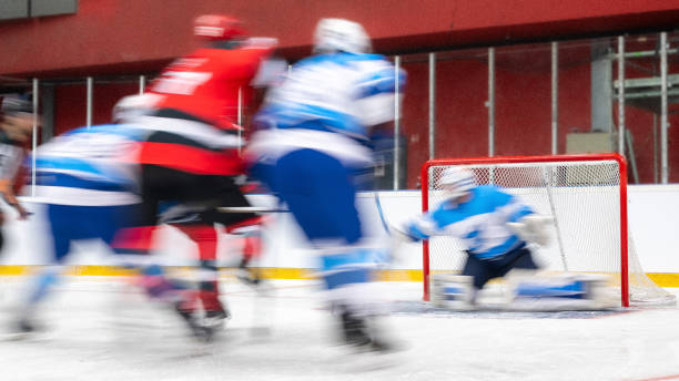 istock Intense Ice Hockey Game with Goalkeeper Defending 2189572450