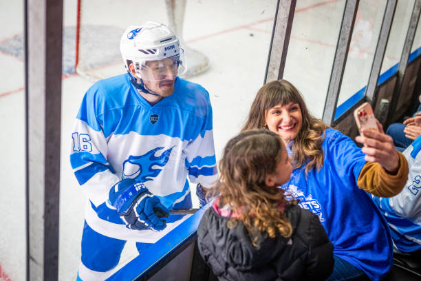 istock Pro Hockey Player Engages with Fans during Break 2189572552