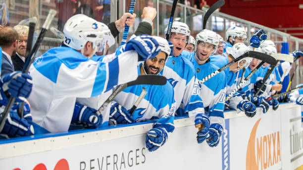 istock Energetic Hockey Team Celebrating by the Ice Rink 2189574100
