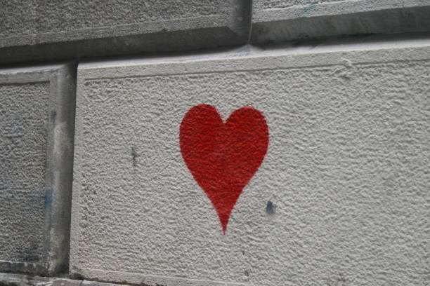 istock Red heart painted on the wall of a building 2189574323