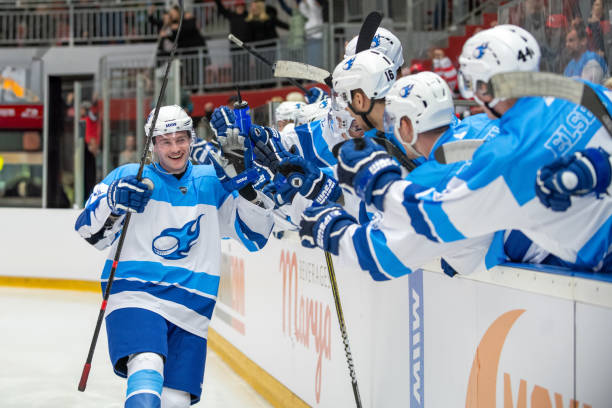 istock Joyful Hockey Player Celebrates Scoring Goal with Teammates 2189574650
