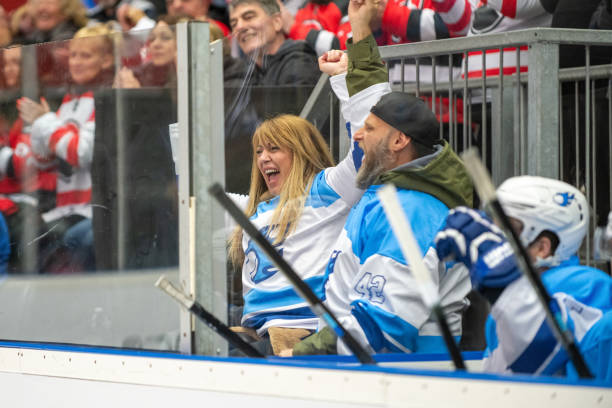 istock Joyful Hockey Enthusiasts Celebrating at Arena 2189574652