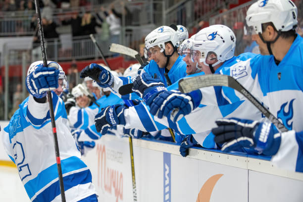 istock Joyful Hockey Player Celebrates Goal with Teammates 2189574666