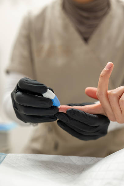 istock Doctor performing finger prick blood test on patient 2189574670