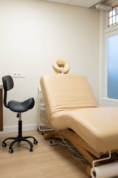 istock Empty massage table in a bright treatment room with modern decor 2189574873