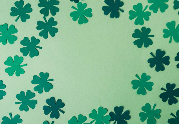 istock Green background with a large green clover in the center 2189576853