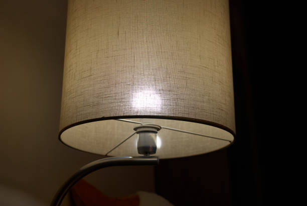 This elegant table lamp produces a soft glow, creating a cozy and inviting ambiance
