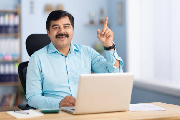 istock Businessman using laptop in office stock photo 2189581640