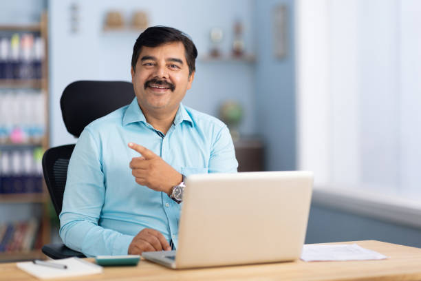 istock Businessman using laptop in office stock photo 2189581685