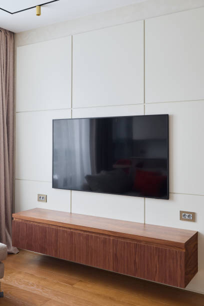 istock A stylish living room with a wallmounted TV, chic decor, and efficient storage options 2189581904