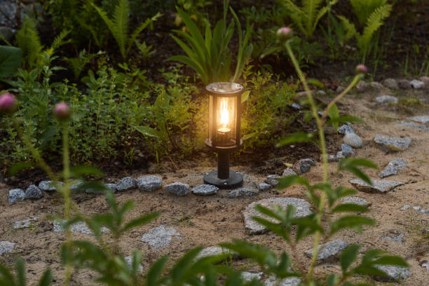 istock An elegant garden lantern illuminates a serene landscape at dusk, creating a warm atmosphere 2189581926