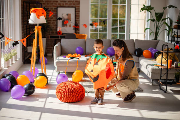 istock Mother and child dressing for Halloween with festive home decorations 2189582010