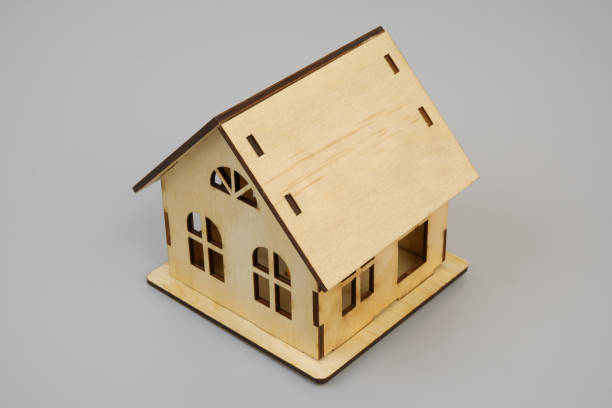 istock Wooden house model on gray 2189583436