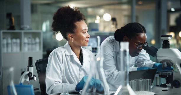 istock Women, microscope and scientist team research in lab for experiment, analysis and biotechnology. Equipment, science collaboration and microbiology for medical development, healthcare and pharma test 2189583510
