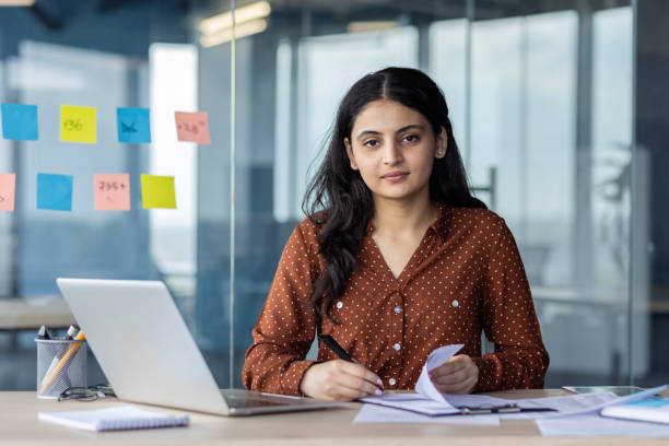 istock Confident businesswoman working at desk in modern office environment 2189583558