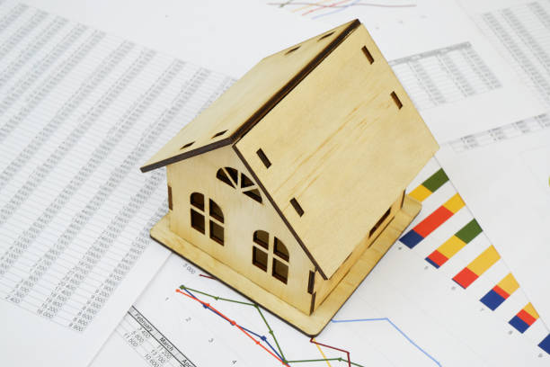 istock Wooden house on financial documents. 2189583641