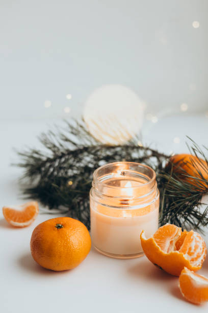 istock Christmas background with fir tree branches, candle and oranges tangerines. 2189583827