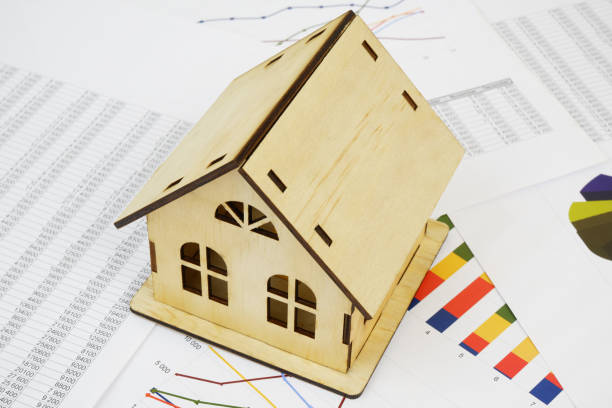 istock Wooden house on financial documents. 2189584005