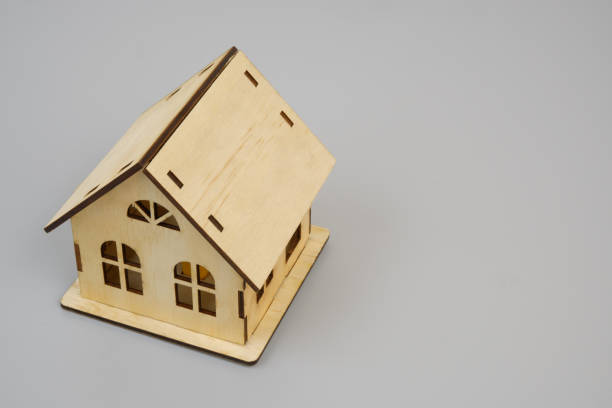 istock Wooden house model on gray 2189584012
