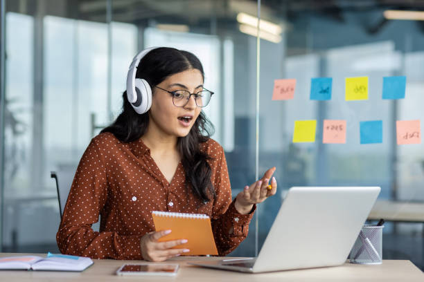 istock Young professional engaging in a virtual meeting from modern office space 2189584641