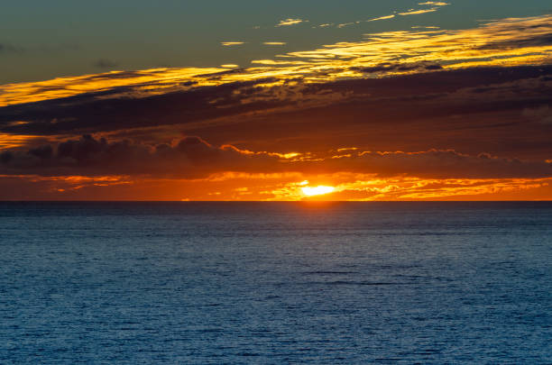 Spain, Fuerteventura, Morro Jable, November 18, 2024 -Sunset over the Atlantic Ocean into the clouds